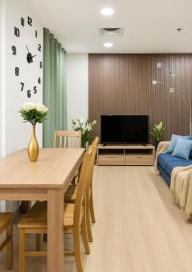 a living room with a table and a television at The Marina Quite Kingdom in Dubai +10 photos
