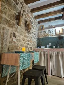 a kitchen with a counter and stools in a room at Agua D Estrellas in Trevejo