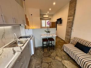 a kitchen with a sink and a couch in a room at Haus Viktoria 4 in Limenas