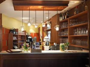 a bar in a restaurant with glasses on shelves at Gasthof Hillig in Bad Gottleuba