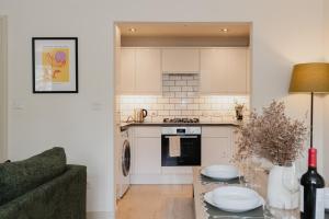 a kitchen and living room with a table and a couch at Duplex Redhill town centre apartment by Livingo Stays in Redhill