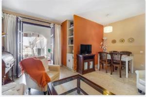 A television and/or entertainment centre at Charming apartment in El Puerto de Santa María with terrace