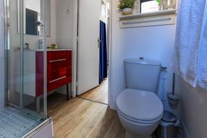 a bathroom with a toilet and a glass shower at Ohana in Deauville +20 photos