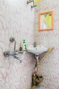 a bathroom with a sink and a mirror at GREEN VISTA HOMESTAY in Guwahati