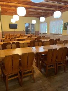 a conference room with wooden tables and chairs at ATC Kemp Kajlovec in Hradec nad Moravici