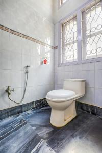 a bathroom with a toilet and a shower at GREEN VISTA HOMESTAY in Guwahati +24 photos