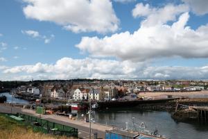 a view of a town with a river and a city at Historic 2BD Maisonette in Coastal Eyemouth in Eyemouth