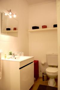 a bathroom with a white sink and a toilet at Nove Julho Apartment in Porto