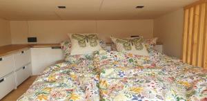 a bed with a colorful comforter in a bedroom at Tiny Frida in Gifhorn