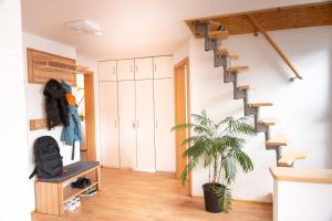 a room with a staircase and a plant at anderswo - Urlaub im Allgäu in Leutkirch im Allgäu +23 photos