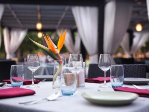 a table with wine glasses and a plate on it at Novotel Hyderabad Convention Centre in Hyderabad