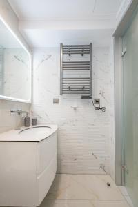 a white bathroom with a sink and a mirror at Diamante Del Mar Crete Rhodes in Kos +48 photos
