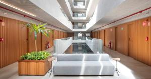 a lobby with a white chair in a building at Setai Yacht in João Pessoa
