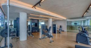 a gym with treadmills and chairs in a room at Setai Yacht in João Pessoa
