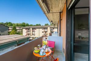 a small table on the balcony of a building at La Dolce Laveno - Happy Rentals in Laveno-Mombello +15 photos