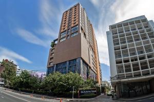 a tall building on the side of a street at Siam@Siam, Design Hotel Bangkok in Bangkok +37 photos