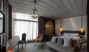 a bedroom with a bed and a couch and a table at Siam At Siam Design Hotel Bangkok in Bangkok +103 photos
