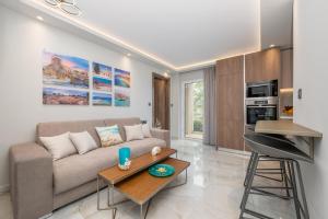 a living room with a couch and a table at Diamante Del Mar Crete Rhodes in Kos