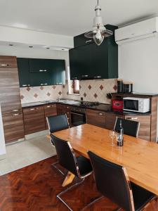 a kitchen with a wooden table and black chairs at Diego in Rijeka