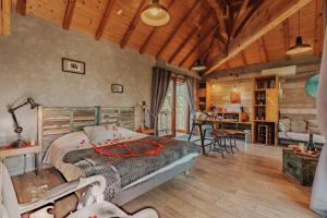 a bedroom with a bed and a table in a room at cabanes perchees dans les arbres in Capdrot +8 photos
