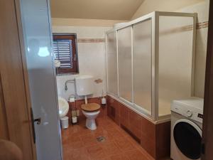 a small bathroom with a toilet and a sink at Diego in Rijeka +12 photos