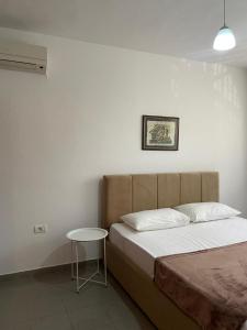 a bedroom with a bed and a small table at Kalpazo Tirana Mosaic in Tirana