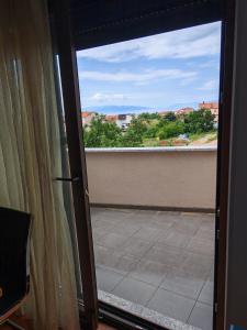 a sliding glass door with a view of a balcony at Diego in Rijeka
