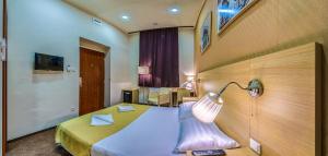 a bedroom with a bed with a lamp on it at Budapest Citi Guesthouse - contactless self check in in Budapest