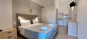 a bedroom with a bed with two towels on it at Anemona Studios in Paleokastritsa