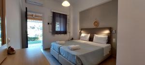a bedroom with a bed with two towels on it at Anemona Studios in Paleokastritsa