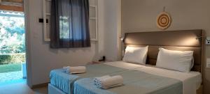 a bedroom with a bed with two towels on it at Anemona Studios in Paleokastritsa