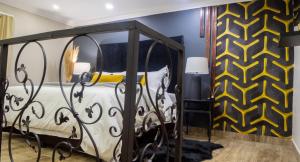 a bedroom with a bed and a yellow and black wall at EGB Guest House in Springs