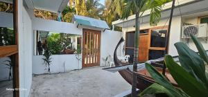 a front door of a house with potted plants at Dhontakuru Guest House in Ariyaddu