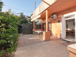 a patio of a house with a table and chairs at Holiday Home Marijana by Interhome in Sukošan