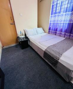 Postel nebo postele na pokoji v ubytování Hotel Ebraj Sylhet