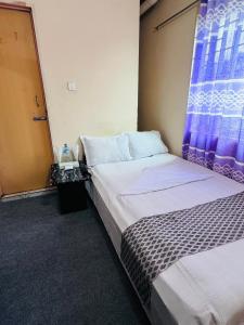 Postel nebo postele na pokoji v ubytování Hotel Ebraj Sylhet