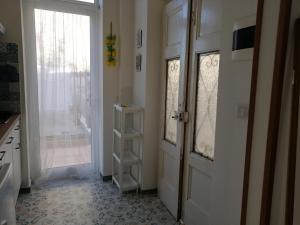 Una cocina con una puerta, una ventana y un estante. en Azzurro Felix, en Procida 23 fotos más