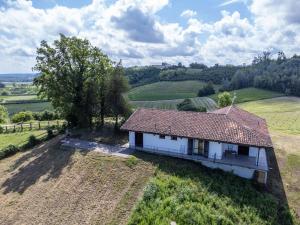 an aerial view of a white house in a field at Holiday Home Elena by Interhome in Azzano d'Asti