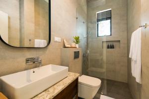 a bathroom with a sink and a toilet and a shower at W15 Ambuluwawa in Gampola +28 photos