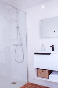 a shower with a glass door in a bathroom at Mar-Ria 7 in Fuzeta +7 photos