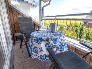 a table and two chairs on a balcony with a table and a table and chairs at Apartment Ballertutje by Interhome in Norddeich