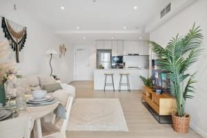 a living room with a couch and a table at Boho retreat near The Gabba with stunning views in Brisbane