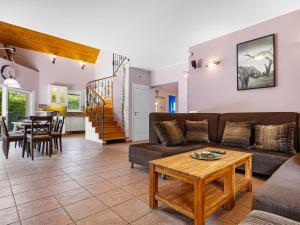 a living room with a couch and a table at Villa Smeraldo by Interhome in Balatonszabadi Fürdőtelep