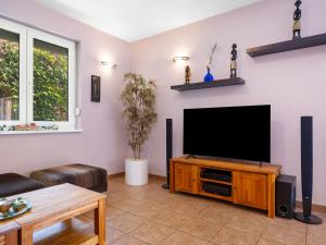 a living room with a flat screen tv at Villa Smeraldo by Interhome in Balatonszabadi Fürdőtelep