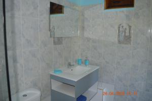 a bathroom with a sink and a toilet at Villa nana in Pointe-Noire +8 photos