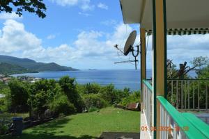 a view of the ocean from the balcony of a house at Villa nana in Pointe-Noire