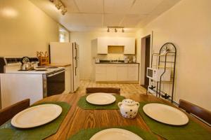 a kitchen and a table with plates on top of it at Suites on Main in Margaretville