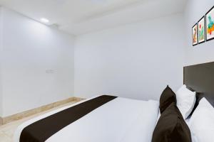Postel nebo postele na pokoji v ubytování Hotel O Grand Heights