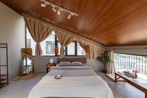 a bedroom with a large bed with a wooden ceiling at Miền Sương Khói Homestay Đà Lạt in Da Lat