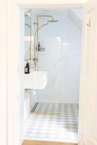 a bathroom with a sink and a shower at Lundsgaard Gods Badehotel in Kerteminde
